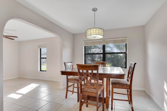 tiled dining space featuring ceiling fan