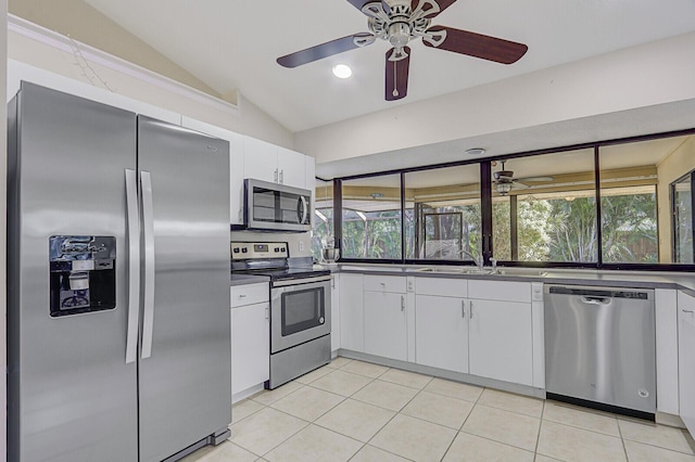 kitchen featuring plenty of natural light, a ceiling fan, white cabinets, lofted ceiling, and stainless steel appliances