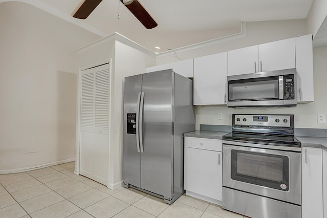 kitchen featuring vaulted ceiling, light tile patterned flooring, white cabinetry, appliances with stainless steel finishes, and ceiling fan