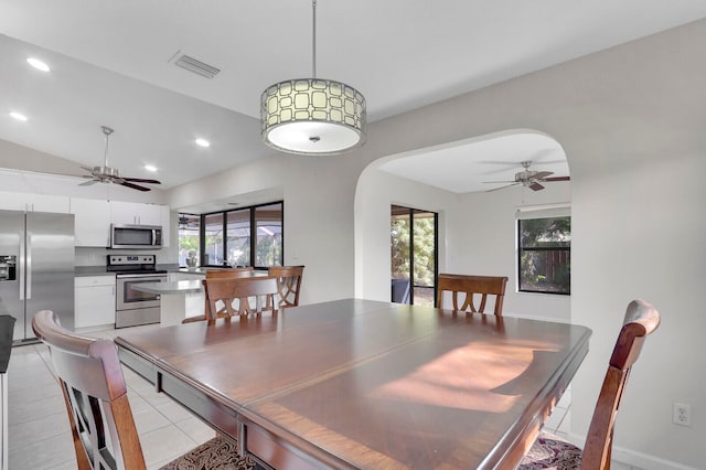 tiled dining room featuring lofted ceiling, ceiling fan, and plenty of natural light