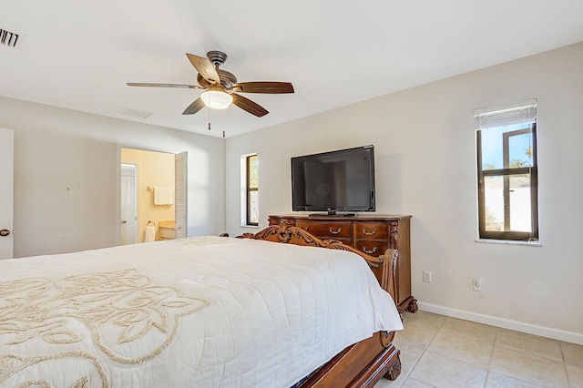 bedroom with ensuite bath, a ceiling fan, baseboards, light tile patterned floors, and visible vents