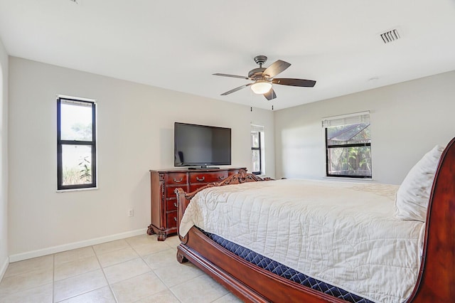bedroom featuring baseboards, visible vents, multiple windows, and tile patterned flooring