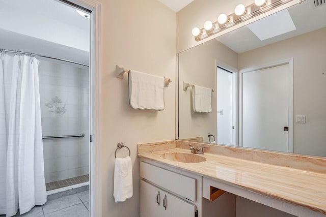 bathroom with tile patterned floors, a shower with shower curtain, and vanity