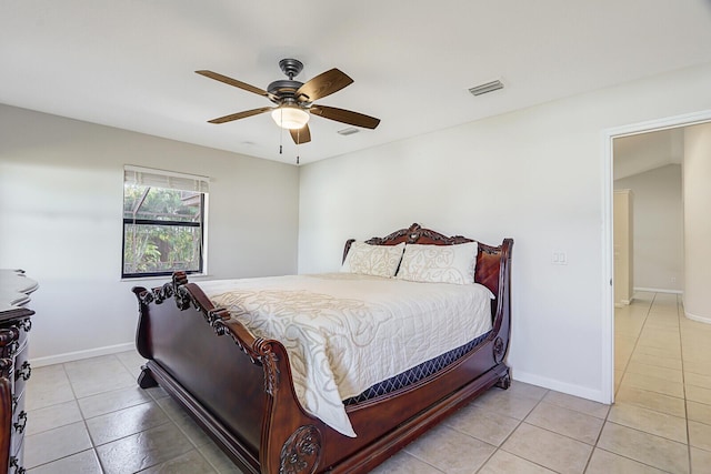 bedroom featuring baseboards, a ceiling fan, and light tile patterned flooring