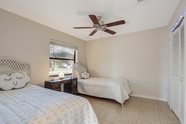 tiled bedroom featuring a closet and ceiling fan