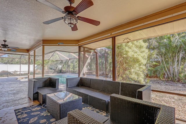 view of patio featuring a fenced in pool, a ceiling fan, glass enclosure, and an outdoor hangout area