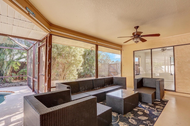 sunroom featuring ceiling fan and outdoor lounge area