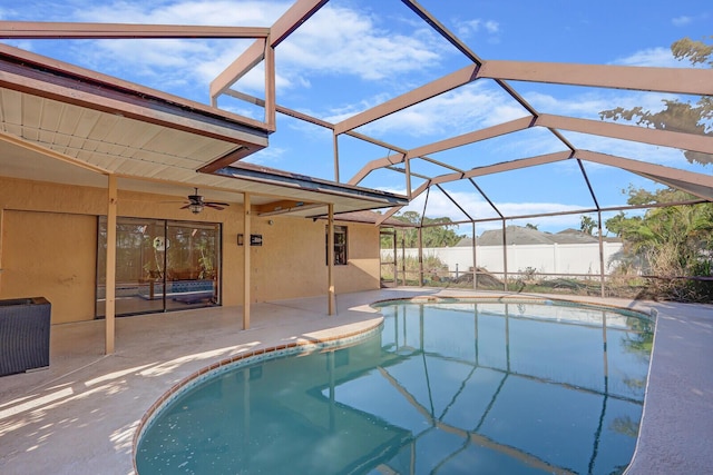 view of pool with a fenced in pool, a ceiling fan, glass enclosure, and a patio area