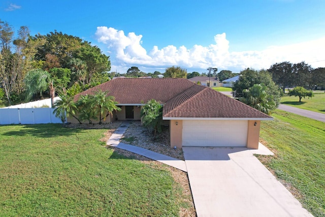 ranch-style house with stucco siding, fence, a front yard, and concrete driveway