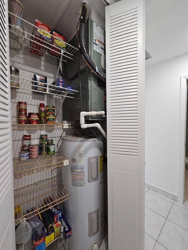 utility room featuring water heater