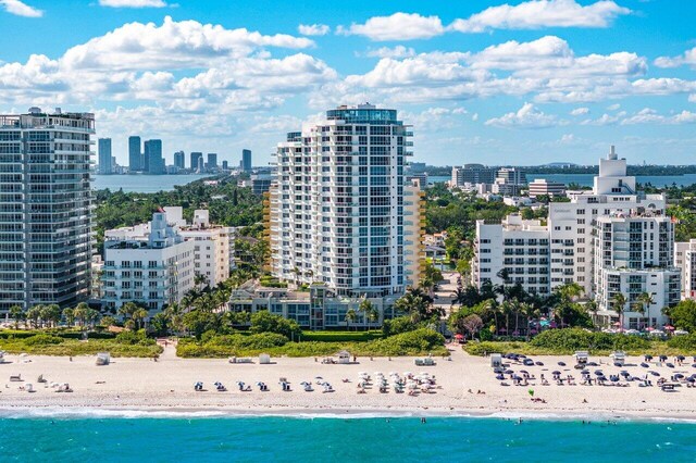 drone / aerial view with a beach view and a water view