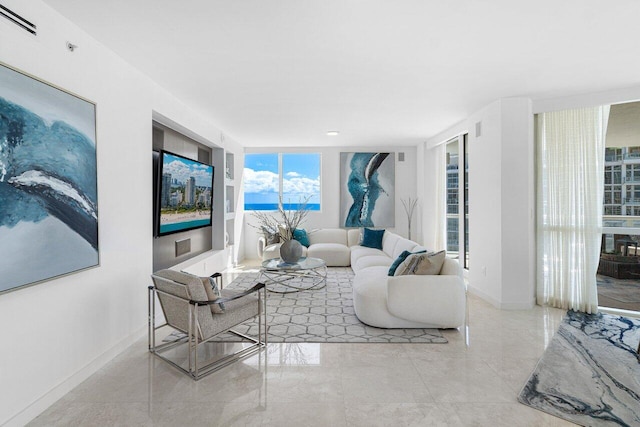 living room with floor to ceiling windows and a wealth of natural light