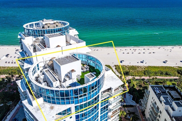 bird's eye view featuring a view of the beach and a water view