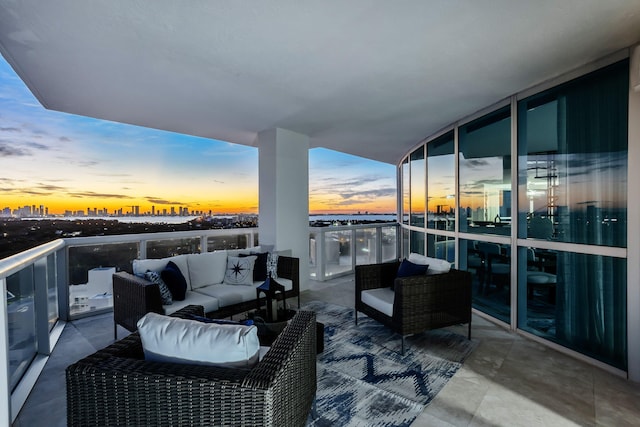 balcony at dusk featuring an outdoor hangout area