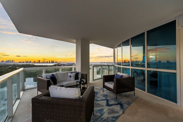 balcony at dusk featuring an outdoor hangout area