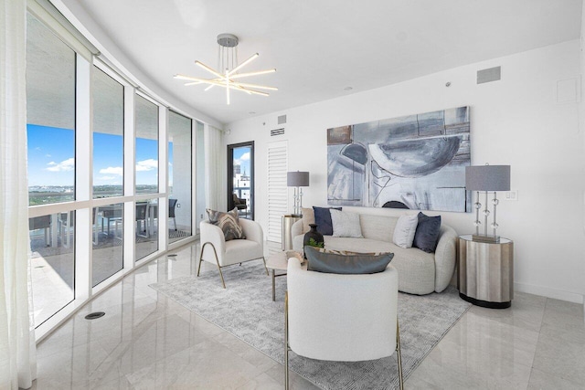 living room featuring a notable chandelier and floor to ceiling windows