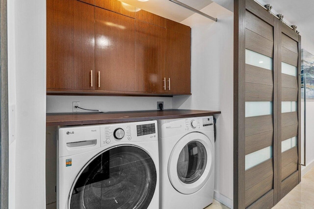 washroom featuring cabinets and independent washer and dryer