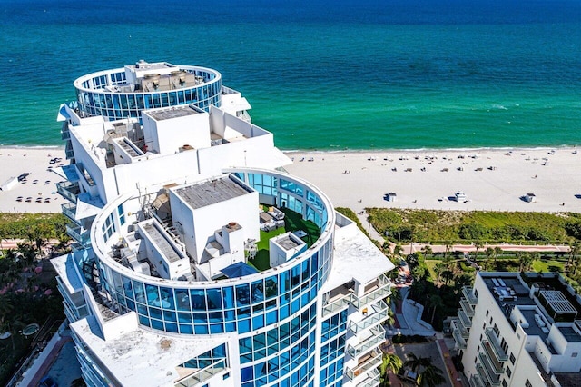 drone / aerial view featuring a water view and a beach view