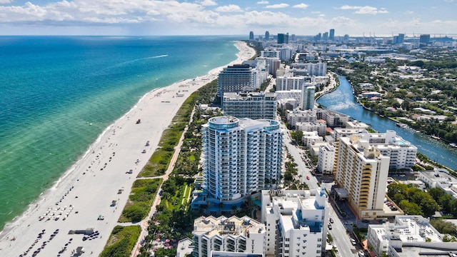 bird's eye view featuring a view of the beach and a water view