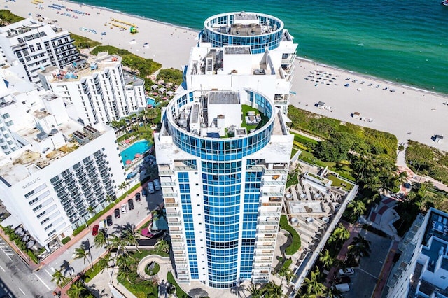 birds eye view of property featuring a view of the beach and a water view