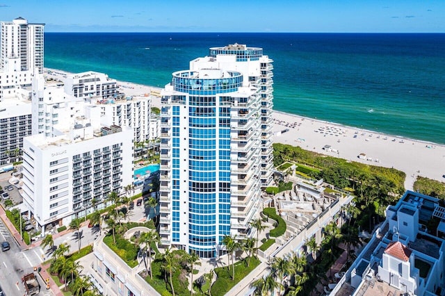 drone / aerial view featuring a water view and a beach view