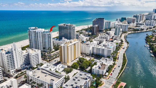 birds eye view of property with a water view and a view of the beach