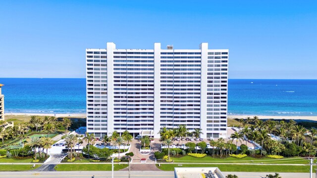 view of property featuring a water view and a beach view