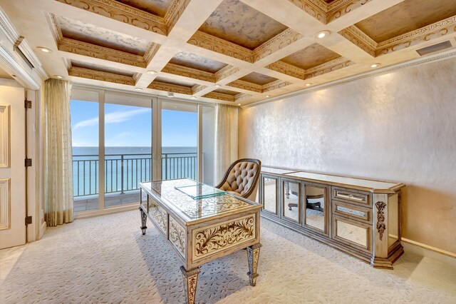 carpeted home office featuring baseboards, coffered ceiling, a water view, crown molding, and beam ceiling