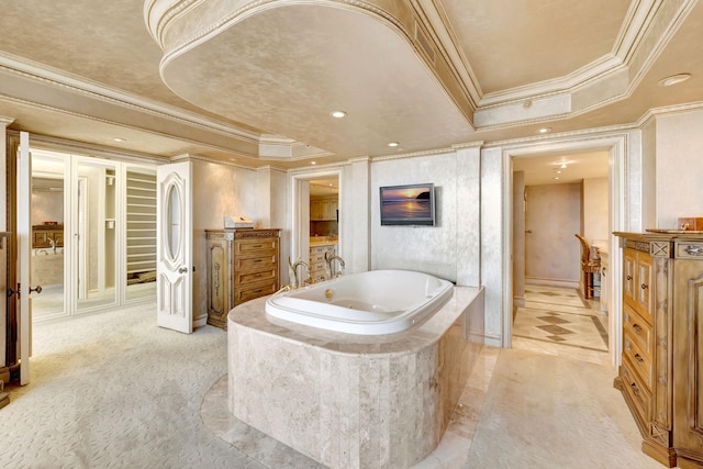 bathroom with ornamental molding, recessed lighting, a raised ceiling, and a whirlpool tub