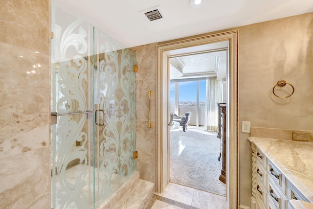 bathroom with a shower with door and visible vents