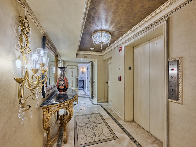 hall with ornamental molding, elevator, and a chandelier