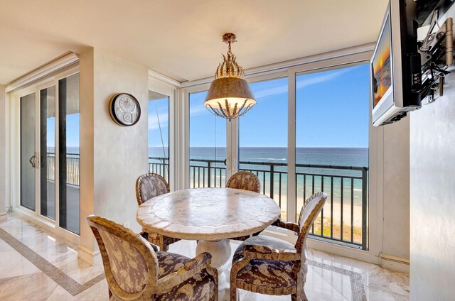 dining room featuring a water view and a view of the beach