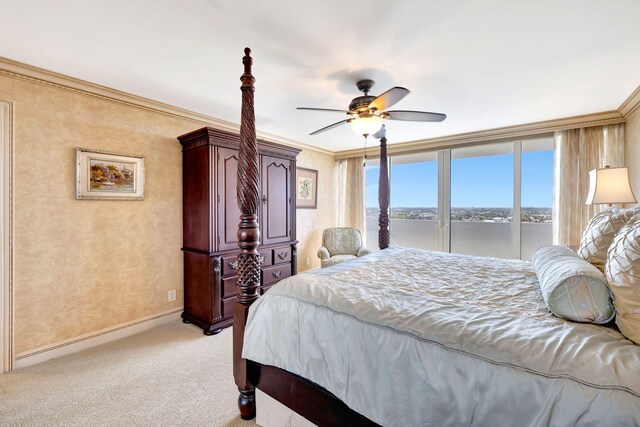 dining space featuring a chandelier, a water view, and crown molding