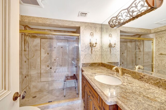 bathroom featuring visible vents, a shower stall, vanity, and wallpapered walls