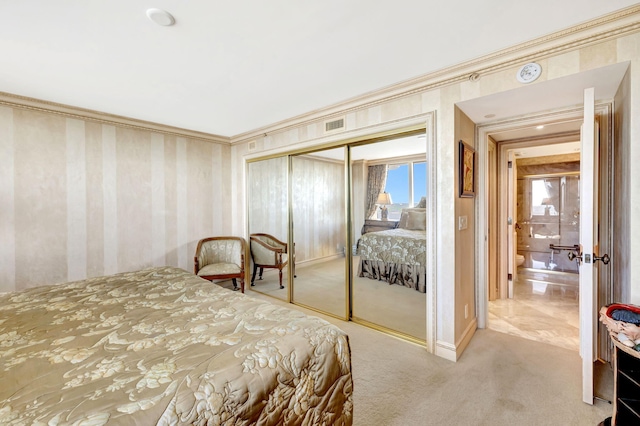 bedroom with a closet, carpet flooring, crown molding, and visible vents