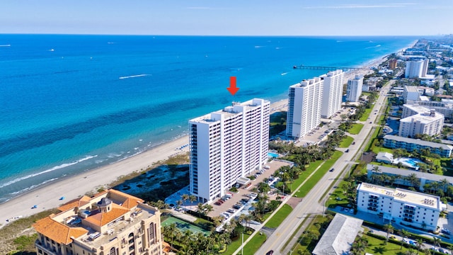 aerial view featuring a water view, a view of the beach, and a city view