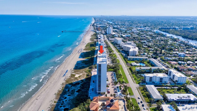 bird's eye view featuring a water view and a view of the beach