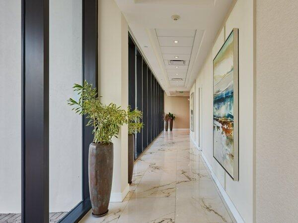 hall featuring marble finish floor, visible vents, baseboards, and recessed lighting