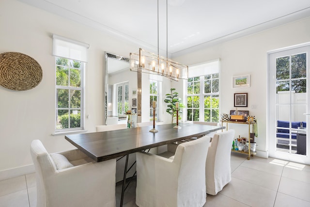 tiled dining space featuring ornamental molding