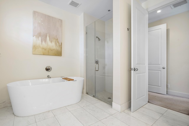 bathroom featuring tile patterned floors and shower with separate bathtub