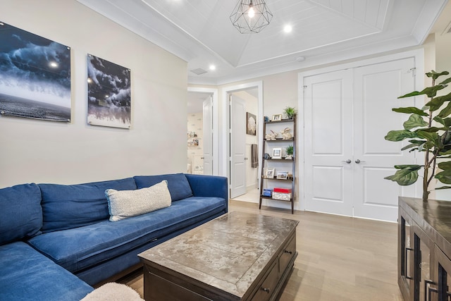 living room featuring light hardwood / wood-style flooring and crown molding