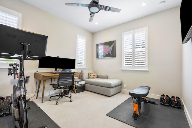 carpeted office featuring ceiling fan and a wealth of natural light