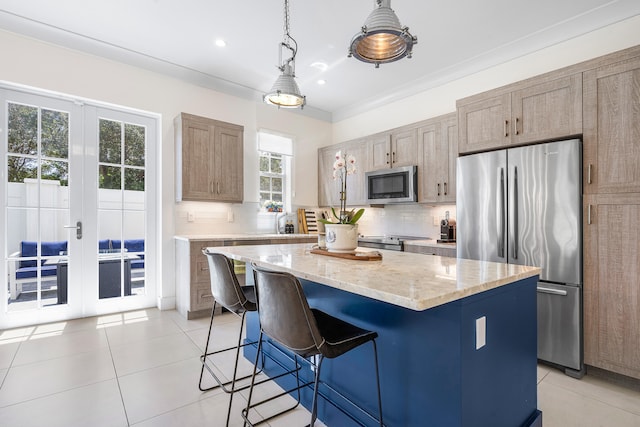 kitchen featuring a kitchen island, backsplash, decorative light fixtures, appliances with stainless steel finishes, and light stone counters