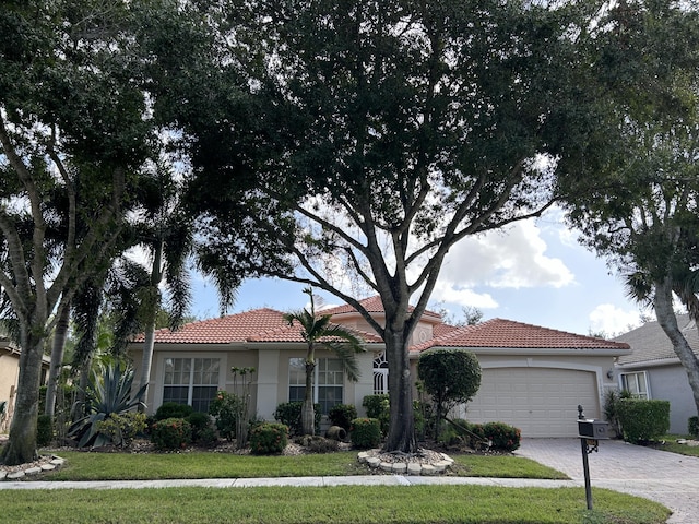 view of front facade with a garage and a front yard