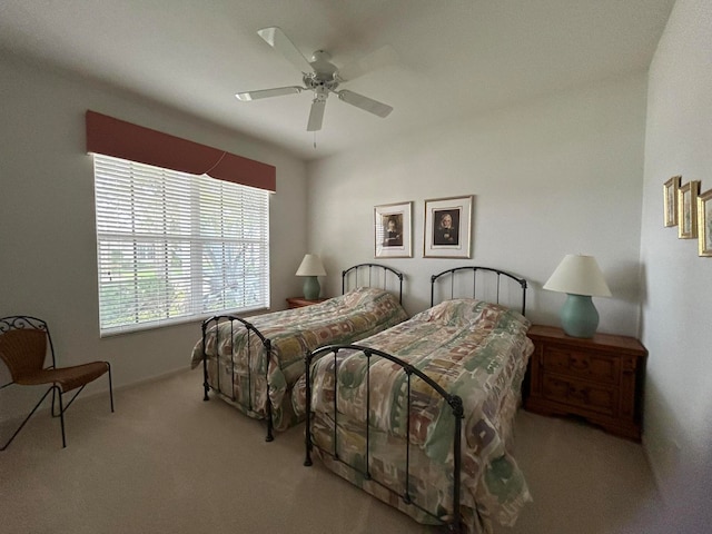 bedroom with ceiling fan and light colored carpet