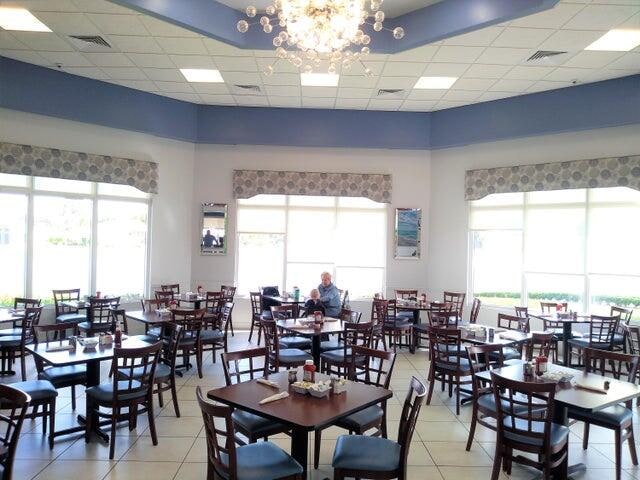 dining space featuring a notable chandelier, light tile patterned floors, and a drop ceiling