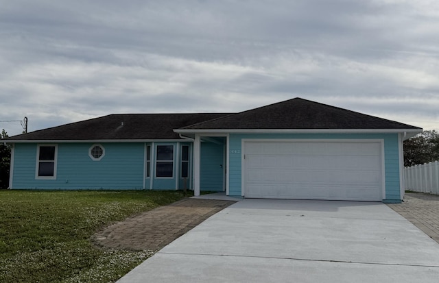 ranch-style home with a garage and a front yard