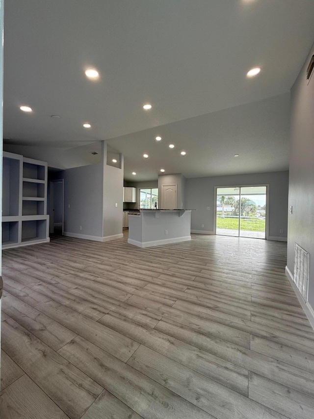 unfurnished living room with light hardwood / wood-style floors