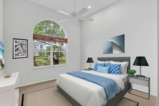 bedroom with ceiling fan and light colored carpet