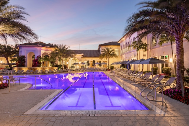 pool at dusk with a patio